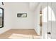 Bright room featuring hardwood floors and light, complemented by a bathroom doorway at 4452 Xavier St, Denver, CO 80212
