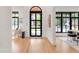 Bright entryway with large arched front door and modern black window frames offer beautiful natural light at 4452 Xavier St, Denver, CO 80212