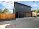 Exterior view of a modern home featuring a multi-car garage with a wooden fence at 4452 Xavier St, Denver, CO 80212