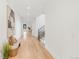 Bright hallway with hardwood floors, white walls, and natural light, leading to the stairs at 4452 Xavier St, Denver, CO 80212