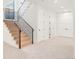 Hallway with staircase features iron railings, carpet, and white walls leading to bedrooms at 4452 Xavier St, Denver, CO 80212
