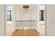 Second story hall with decorative hanging lamp, hardwood floors, and iron railing at 4452 Xavier St, Denver, CO 80212