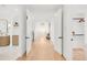Long hallway with an open entryway, a hanging light fixture, and wood floors at 4452 Xavier St, Denver, CO 80212