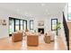 Open-concept living room with fireplace, wood floors, neutral tones, and ample natural light at 4452 Xavier St, Denver, CO 80212