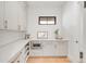 Well-organized pantry with custom cabinets, marble countertop, stainless microwave, and a window at 4452 Xavier St, Denver, CO 80212