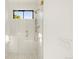 Contemporary shower with glass doors, and gold fixtures with a light tile design at 4452 Xavier St, Denver, CO 80212