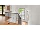 Modern staircase with metal railings, hardwood steps, and large windows offers bright view at 4452 Xavier St, Denver, CO 80212
