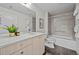 Modern bathroom with gray tile surround, white vanity with sink, and white cabinets at 3480 E 31St Ave, Denver, CO 80205