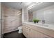 Modern bathroom features a glass shower, double vanity, and sleek fixtures at 3480 E 31St Ave, Denver, CO 80205