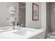 Modern bathroom with gray tile surround, white vanity with sink, and stylish chrome faucet at 3480 E 31St Ave, Denver, CO 80205