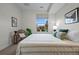 Bright bedroom with a large window, a bed with plush pillows, and stylish decor at 3480 E 31St Ave, Denver, CO 80205