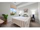 Bright bedroom with a large window, a bed with plush pillows, and stylish decor at 3480 E 31St Ave, Denver, CO 80205