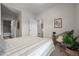 Bright bedroom with a large window, a bed with plush pillows, stylish decor, and ensuite bath at 3480 E 31St Ave, Denver, CO 80205