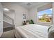 Bright bedroom with a large window, a bed with plush pillows, and stylish decor at 3480 E 31St Ave, Denver, CO 80205