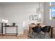 Bright dining room with modern lighting fixture, wood table and black chairs at 3480 E 31St Ave, Denver, CO 80205
