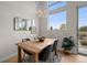 Bright dining room with modern lighting fixture, wood table and large windows at 3480 E 31St Ave, Denver, CO 80205