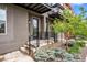 Modern townhome entrance with landscaping, gray exterior and a black door and iron railing at 3480 E 31St Ave, Denver, CO 80205
