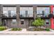 Modern townhomes with black iron railings and gray exterior paint, plus a small balcony at 3480 E 31St Ave, Denver, CO 80205