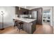 Modern kitchen featuring quartz countertops, stainless steel appliances, and a breakfast bar at 3480 E 31St Ave, Denver, CO 80205