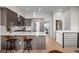 Open-concept kitchen with stainless steel appliances, quartz countertops, and a breakfast bar at 3480 E 31St Ave, Denver, CO 80205