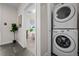 Convenient laundry area with stacked washer and dryer in a hallway setting at 3480 E 31St Ave, Denver, CO 80205