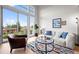Bright living room with large windows, hardwood floors, and comfortable furniture at 3480 E 31St Ave, Denver, CO 80205