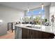 Open-concept living space with kitchen island and dining area at 3480 E 31St Ave, Denver, CO 80205