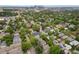 Scenic aerial view of a neighborhood, featuring tree-lined streets and a distant city skyline at 3424 W 31St Ave, Denver, CO 80211