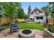 Beautiful backyard with manicured lawn, fire pit, and patio seating area at 3424 W 31St Ave, Denver, CO 80211