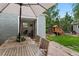 Outdoor patio with seating area and playhouse nestled in a lush backyard at 3424 W 31St Ave, Denver, CO 80211