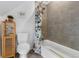 Modern bathroom featuring a tiled shower/tub combination, toilet, and storage cabinet at 3424 W 31St Ave, Denver, CO 80211