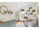 Bright Bedroom with a rocking chair, changing table, crib, decorative shelves and window with blinds at 3424 W 31St Ave, Denver, CO 80211
