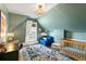 Stylish Bedroom with an angled ceiling, hardwood floors, and soft, colorful decor at 3424 W 31St Ave, Denver, CO 80211