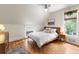 Bright bedroom with hardwood floors, large windows and a comfortable bed with stylish decor at 3424 W 31St Ave, Denver, CO 80211