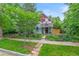 Charming two-story home with colorful exterior, landscaped yard, and wrought iron fence at 3424 W 31St Ave, Denver, CO 80211