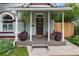 Charming front porch with swing, potted flowers, and painted wood columns at 3424 W 31St Ave, Denver, CO 80211