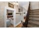 Inviting hallway featuring classic wallpaper, hardwood floors, and a staircase with a carved wood banister at 3424 W 31St Ave, Denver, CO 80211