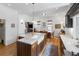 Bright kitchen featuring an island with a marble countertop and a farmhouse sink at 3424 W 31St Ave, Denver, CO 80211