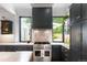 Gourmet kitchen with stainless steel appliances, marble counters and dark cabinets at 3424 W 31St Ave, Denver, CO 80211