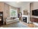 Cozy living room with a decorative fireplace, large arched window, and stylish decor at 3424 W 31St Ave, Denver, CO 80211