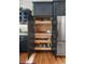 Kitchen pantry featuring pull-out shelving and modern cabinetry at 3424 W 31St Ave, Denver, CO 80211