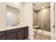 Modern bathroom features a walk-in shower, dark vanity and updated sink and lighting fixtures at 3979 Descent St, Castle Rock, CO 80108