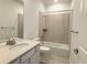Neutral bathroom features a single sink vanity, shower-tub combo, and modern fixtures at 3979 Descent St, Castle Rock, CO 80108