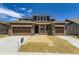 Two-story home features a 3-car garage, stone accents, covered porch and freshly landscaped front yard at 3979 Descent St, Castle Rock, CO 80108