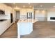 Bright kitchen featuring white cabinets, stainless steel appliances, and a spacious island at 3979 Descent St, Castle Rock, CO 80108