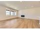 Bright living room features hardwood flooring, a fireplace and multiple windows with great views at 3979 Descent St, Castle Rock, CO 80108