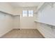 Walk-in closet with carpet and built in shelves and multiple windows for natural light at 3979 Descent St, Castle Rock, CO 80108