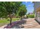 Home's wooden deck showcases mature trees, green grass, and a view of the yard at 5441 Lynx St, Frederick, CO 80504