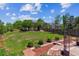 Large, meticulously landscaped backyard with flagstone walkway and a custom fire pit at 5441 Lynx St, Frederick, CO 80504