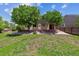 Expansive backyard featuring a brick patio and mature trees, offering ample space for outdoor entertaining at 5441 Lynx St, Frederick, CO 80504